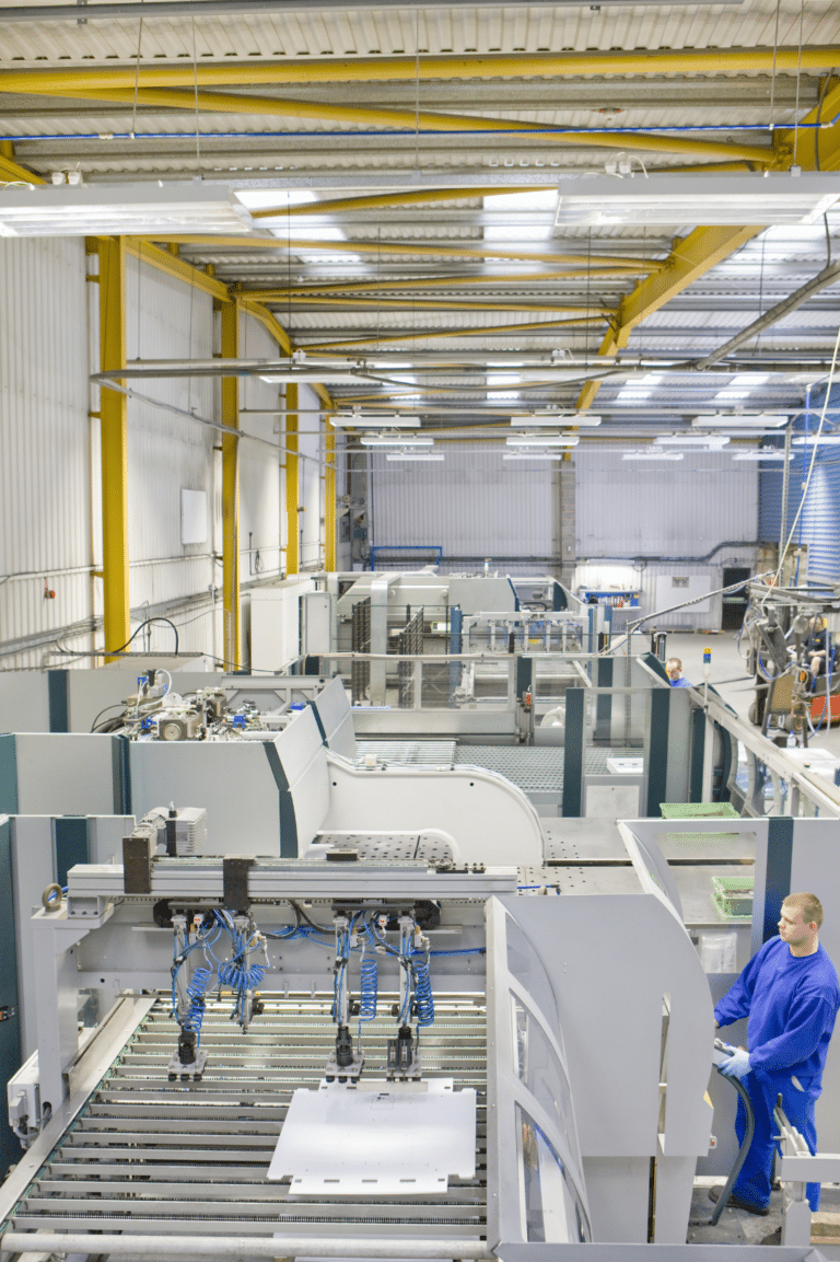 Workers on manufacturing production line - VoIP and paging communication systems for industrial facilities