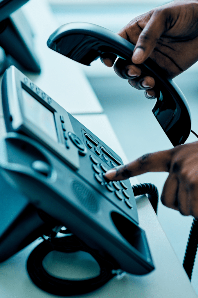 Person dialing desk phone - STIR SHAKEN caller ID authentication and trusted outbound calling