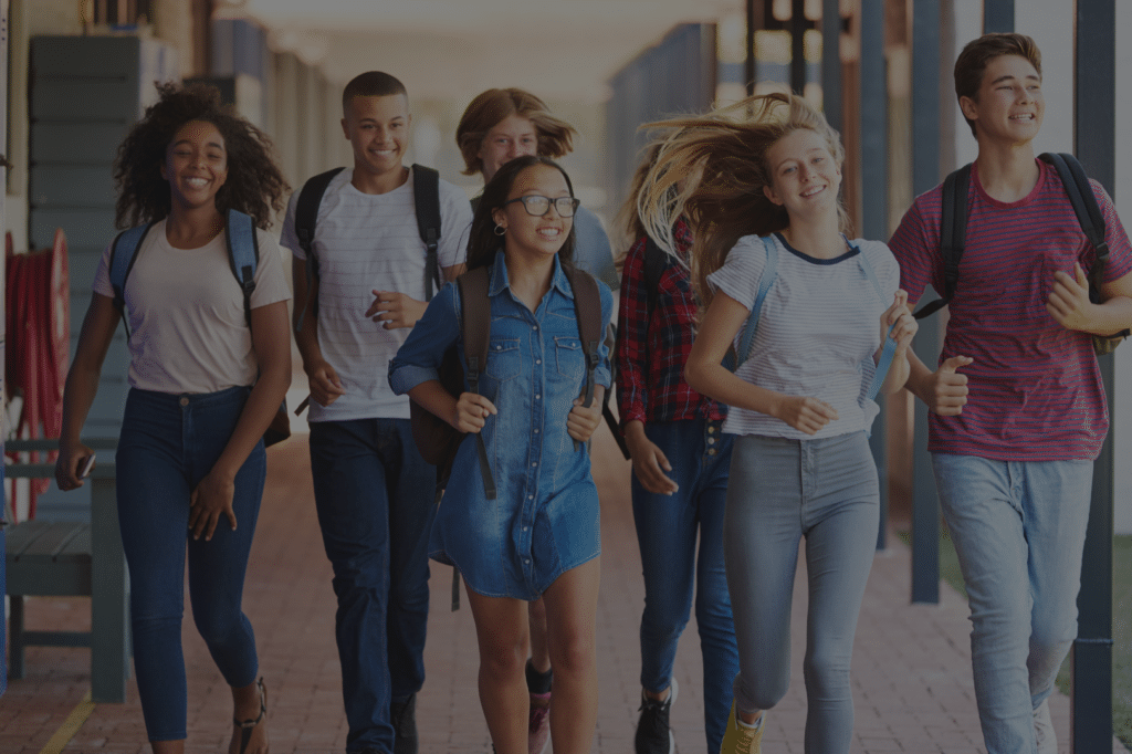 High school students walking through school campus hallway - K-12 communication systems by Ambit Solutions